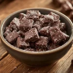 Bowl of homemade Muddy Buddies with powdered sugar