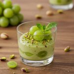 Pistachio pudding recipe with grapes served in a glass cup